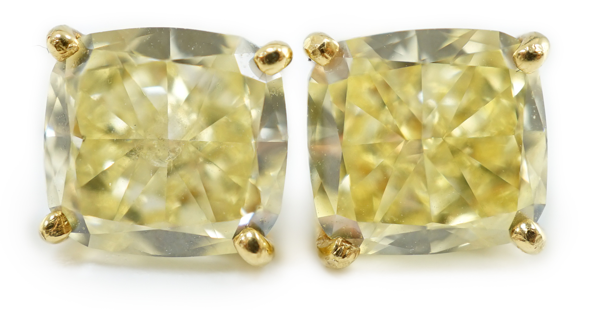 A fine pair of Graf platinum and 18ct white gold set cushion modified brilliant cut natural fancy yellow diamond ear studs